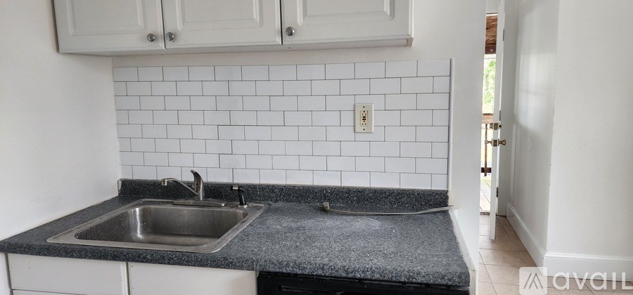 A kitchen with a sink and a counter.