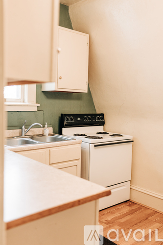 A kitchen with a stove and sink.