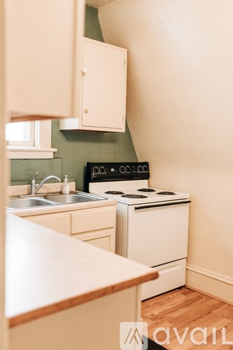 A kitchen with a stove and sink.