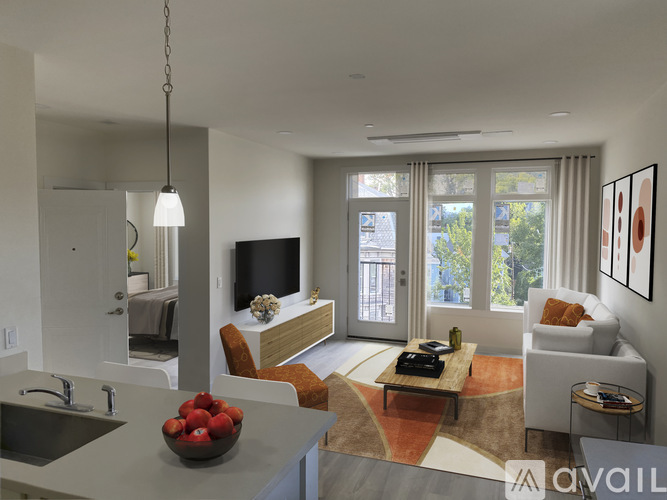 A modern kitchen with a dining area and a living room.