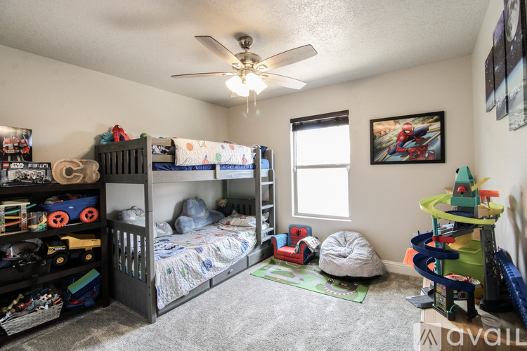 A room with two bunk beds and a play area for children.