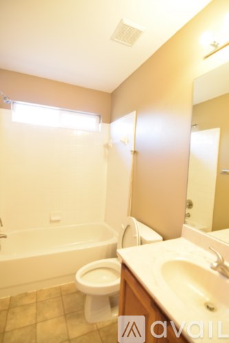 A bathroom with a toilet, sink, and bathtub.