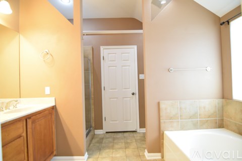 A bathroom with a tub, sink, and toilet.