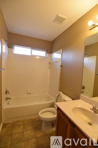 A bathroom with a toilet, sink, and bathtub.