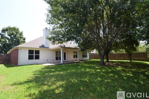 A house with a tree in front of it.