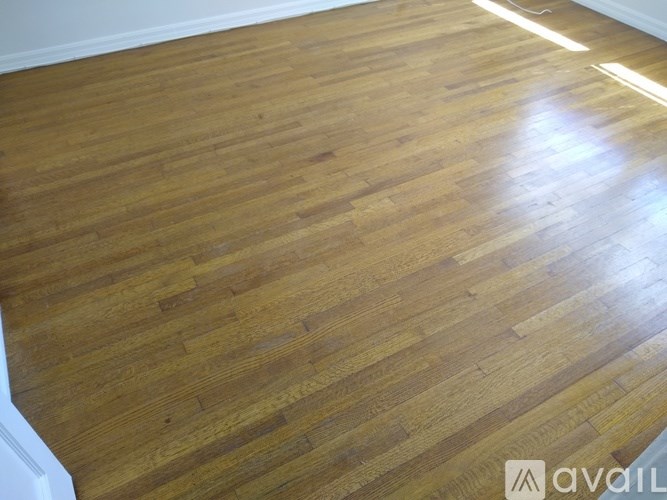 A wooden floor with a light shining on it.