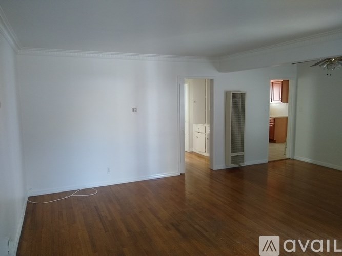A room with wooden floors and white walls.