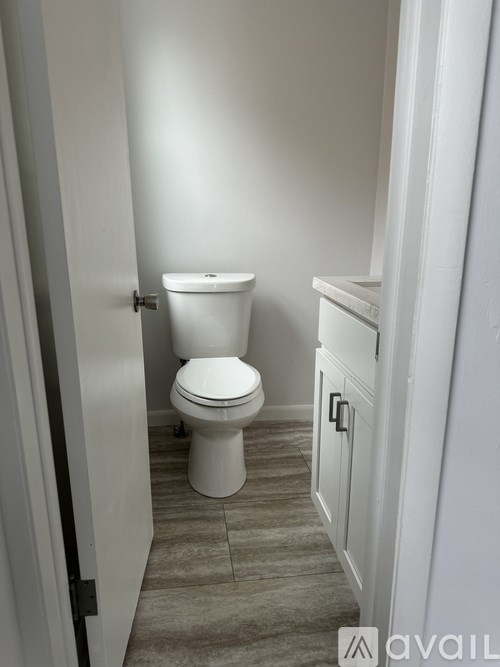 A white toilet in a small bathroom.