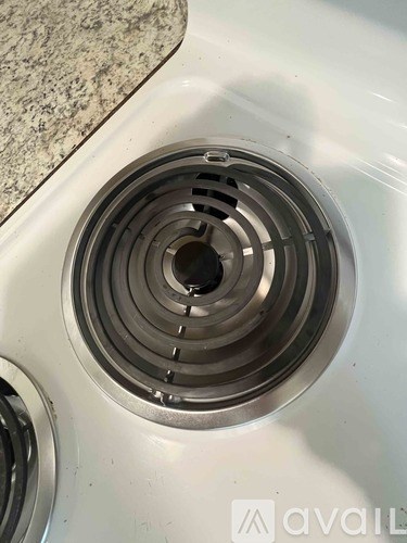 A close up of a sink drain with a metallic finish.