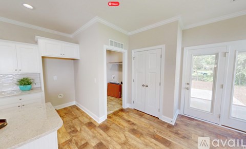 A kitchen with white cabinets and a countertop.