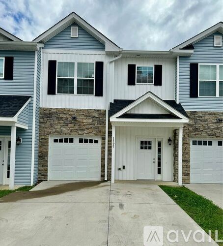 A two-story house with a garage on the first floor.