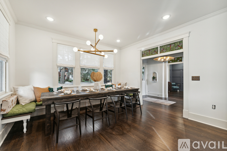 A dining room with a long table and chairs.