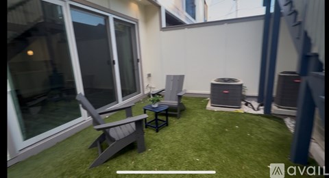 A bedroom with a bed, a desk, and a ceiling fan.