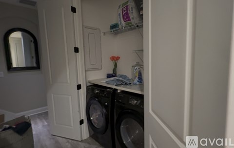 A small laundry room with a washer and dryer.