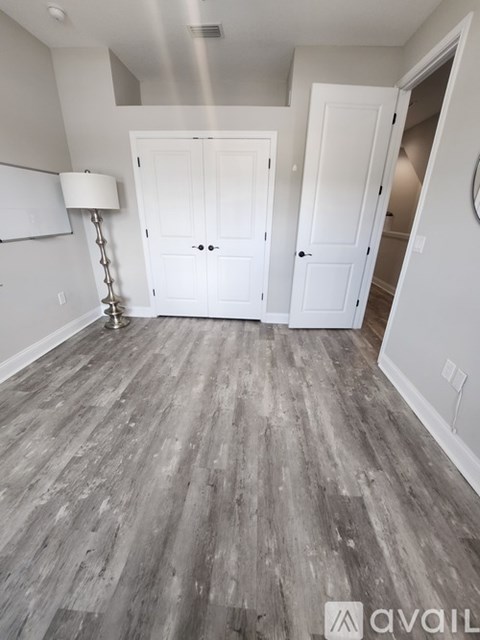 A room with a grey floor and white walls.