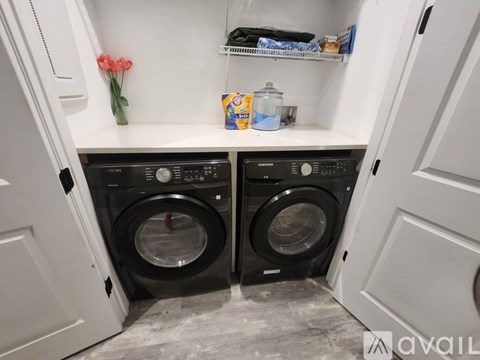 A small laundry room with two front loading washing machines.