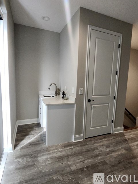 A bathroom with a sink and a door.