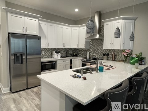 A modern kitchen with a large island and stainless steel appliances.