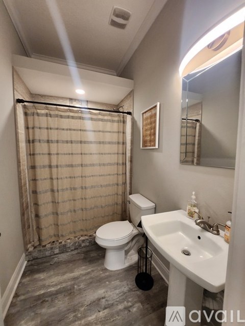 A bathroom with a tub, shower, and a window.