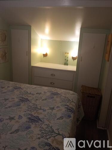 A bedroom with a bed, dresser, and mirror.