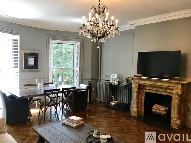 A living room with a fireplace and a television.