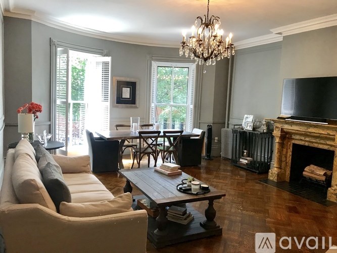 A living room with a fireplace and a chandelier.
