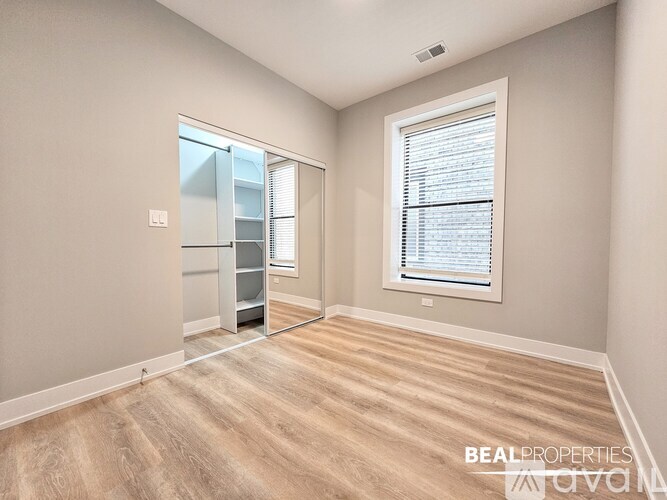 A spacious room with a sliding glass door and a window with blinds.