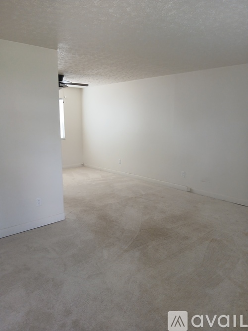 A room with a carpeted floor and white walls.
