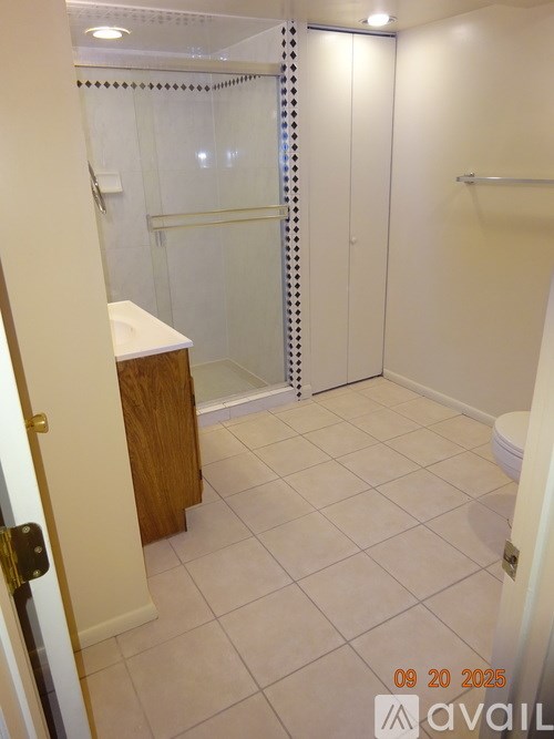 A bathroom with a toilet, sink, and shower.