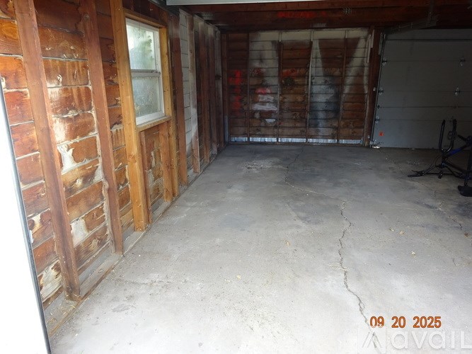 A room with wooden walls and a concrete floor.