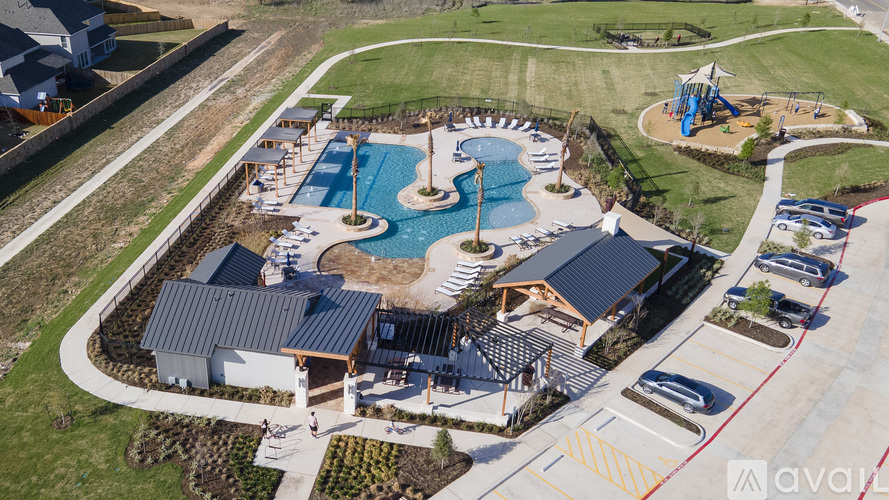 An aerial view of a resort with a swimming pool and a water slide.