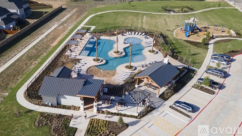 An aerial view of a resort with a swimming pool and a water slide.