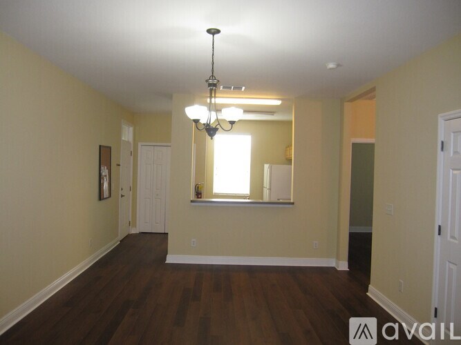A room with a chandelier and a window.
