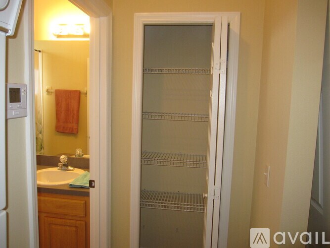 A bathroom with a white door and a sink.