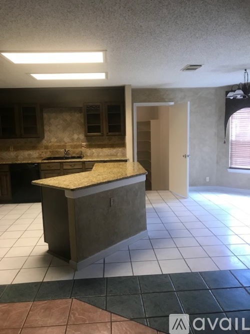 A kitchen with a counter and a sink.
