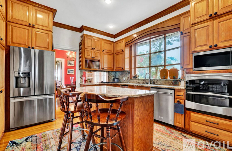 A kitchen with wooden cabinets and a center island.