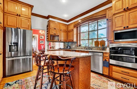 A kitchen with wooden cabinets and a center island.