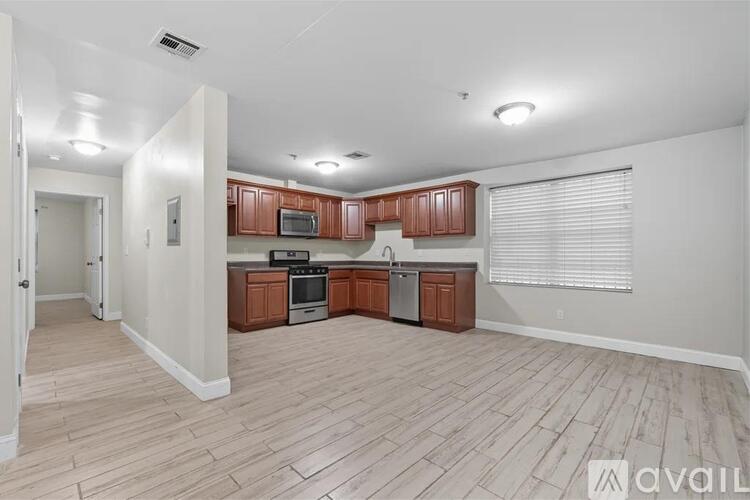 A kitchen with wooden cabinets and a stainless steel oven.