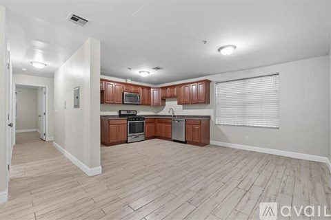A kitchen with wooden cabinets and a stainless steel oven.