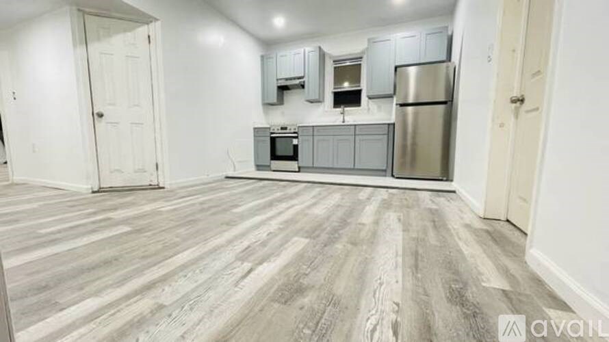 A kitchen area with a refrigerator, microwave, and oven.