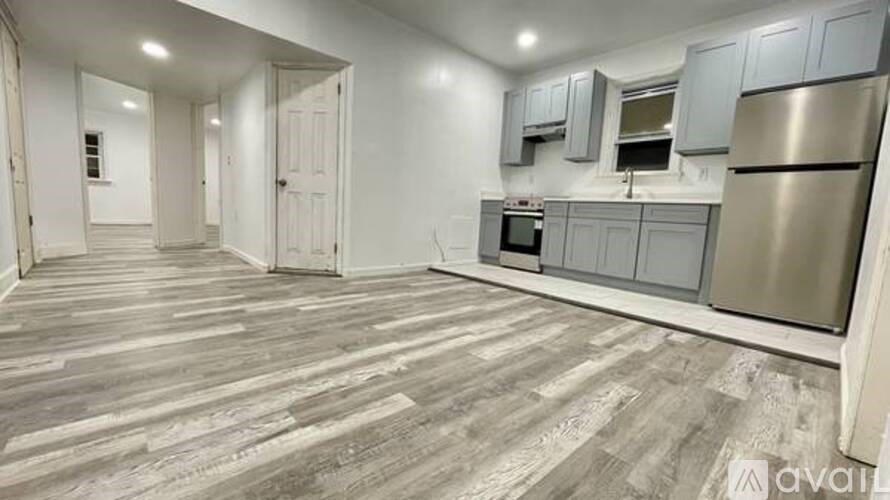 A kitchen with a refrigerator, microwave, and cabinets.