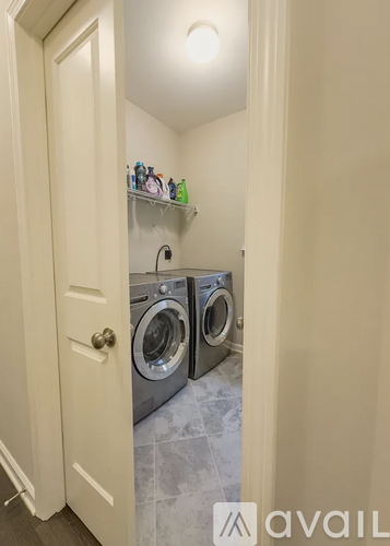 A small laundry room with a washer and dryer.