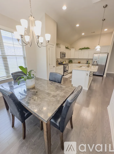 A modern kitchen with a dining table and chairs.