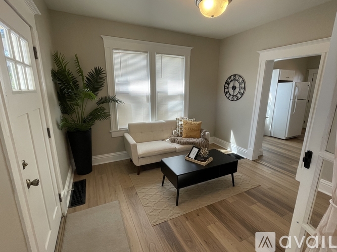 A room with a white door and a window.