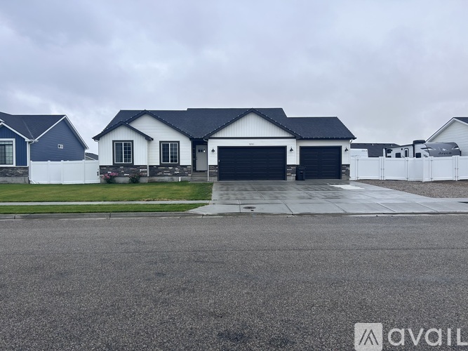 A row of houses with a driveway in front.