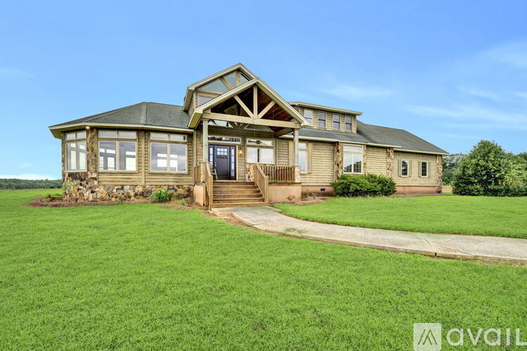 A house with a green lawn in front of it.