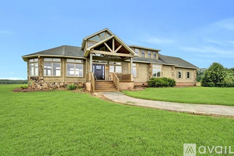 A house with a green lawn in front of it.