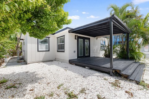 A spacious kitchen with white cabinets and a ceiling fan.