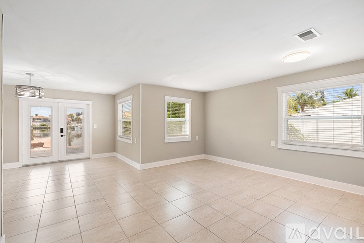 A blue boat is docked at a pier.