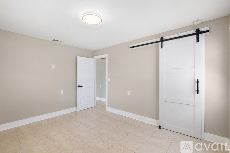 A white toilet sits in a bathroom with a glass shower door.